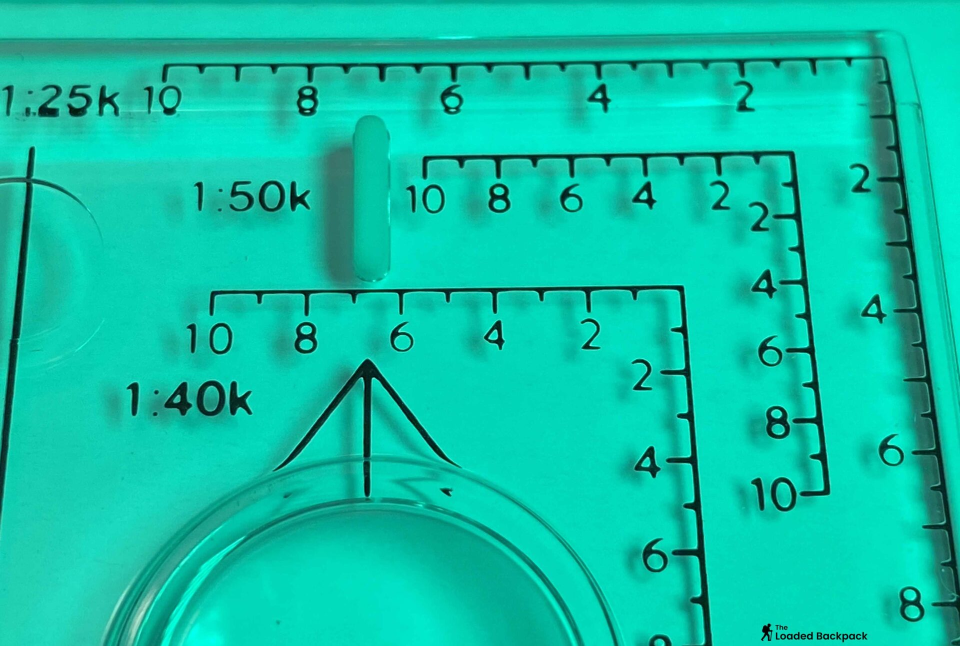 Close-up of the Romer scale on a baseplate compass aligned perfectly within an OS Explorer map grid square